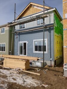 scaffolding set up and siding installation in progress