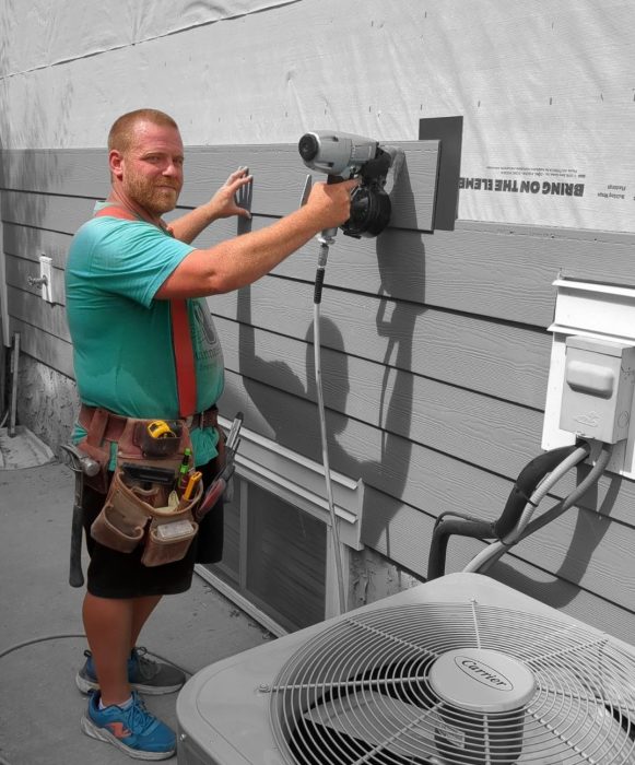 owner Shayne McCoy installing James Hardie Siding